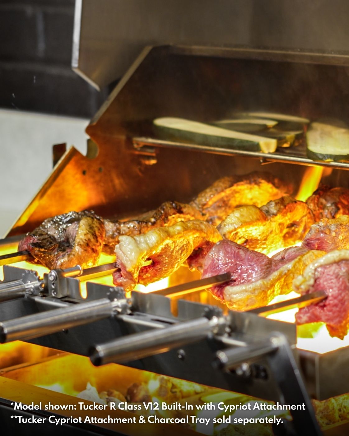 Picanha beef cooking on Cypriot skewers over flames on a Tucker R Class BBQ, with zucchini on the warming rack