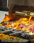 Picanha beef cooking on Cypriot skewers over flames on a Tucker R Class BBQ, with zucchini on the warming rack