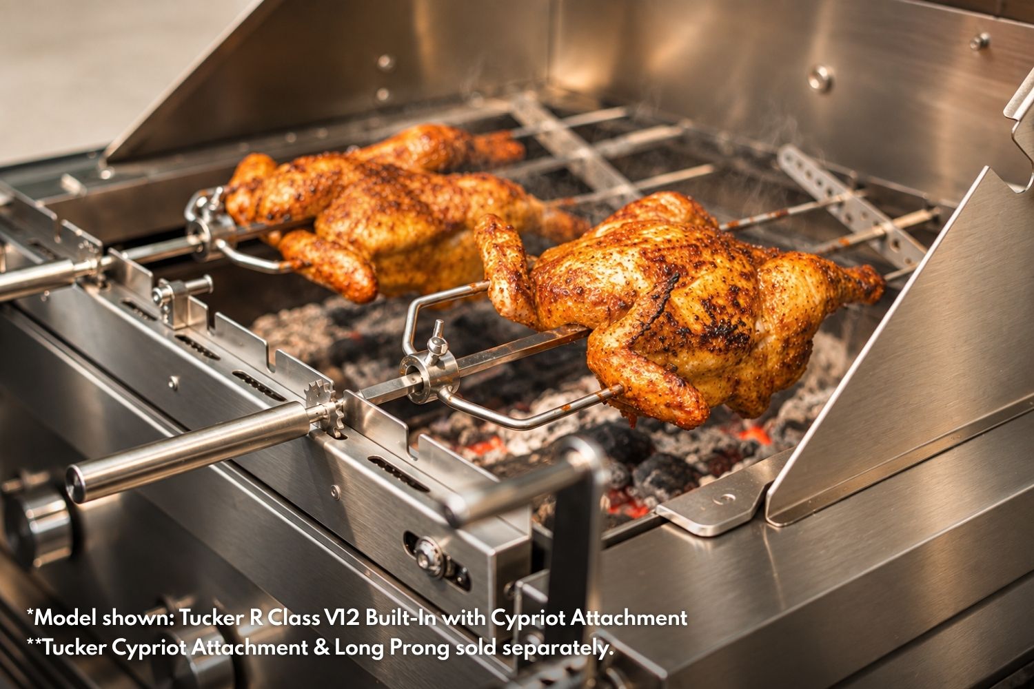 Two whole chickens roasting over charcoal on Tucker R Class Cypriot skewers with Tucker Long Prong