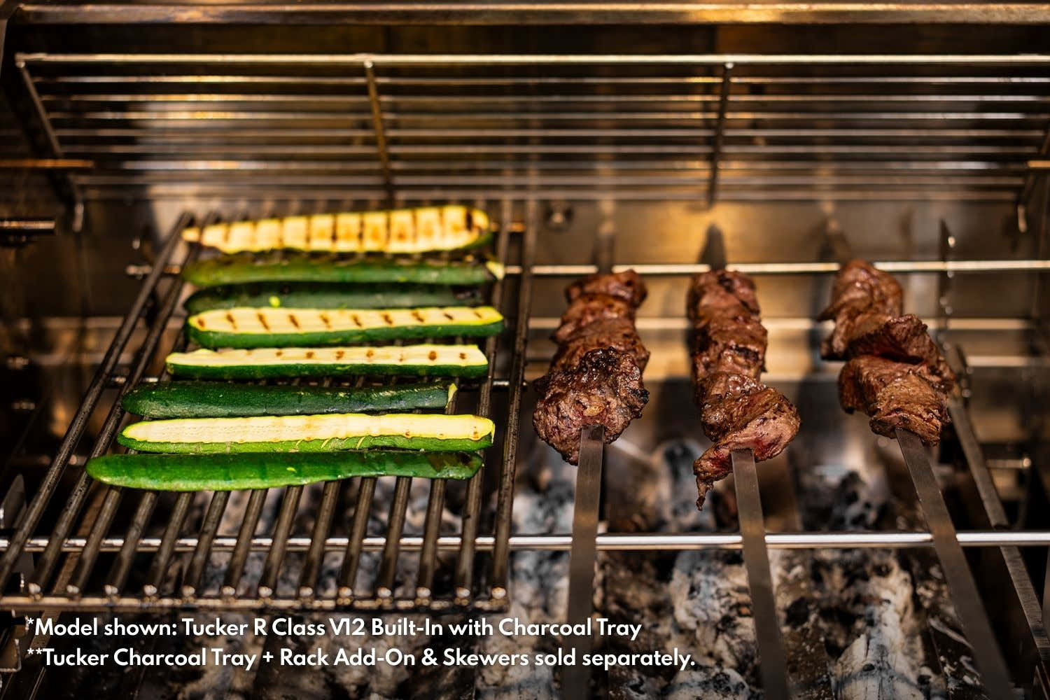 Zucchini on the grill beside beef skewers cooking over a Tucker R Class BBQ charcoal tray